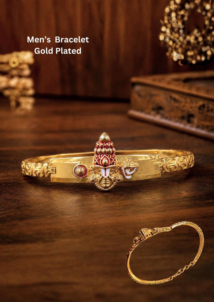 Elegant gold plated men’s bracelet featuring a traditional kada-style design with intricate engraved patterns and a central Tirupati Balaji inspired motif. The bracelet showcases detailed red and white enamel accents with a rich antique gold finish, creating a spiritual and royal appearance suitable for daily wear, temple visits, festive occasions and cultural events.