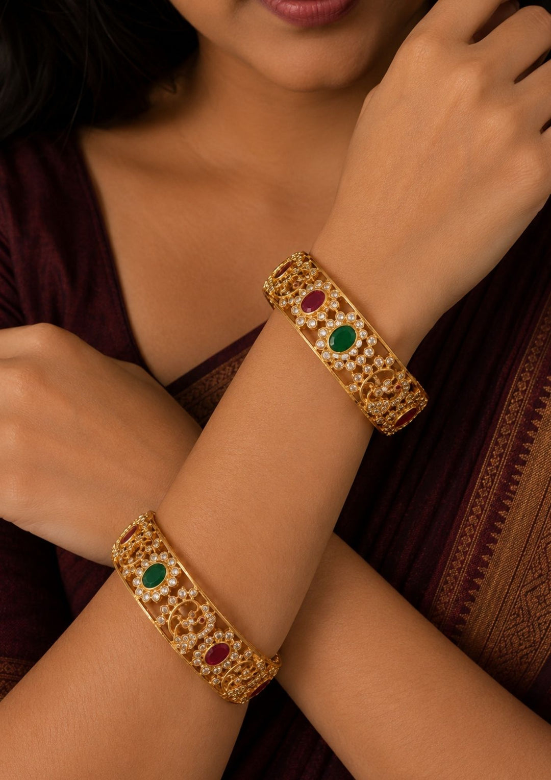 South Indian women wearing a Premium gold plated temple bangles featuring peacock motifs, ruby and emerald stones, sparkling kundan work, and intricate traditional craftsmanship.