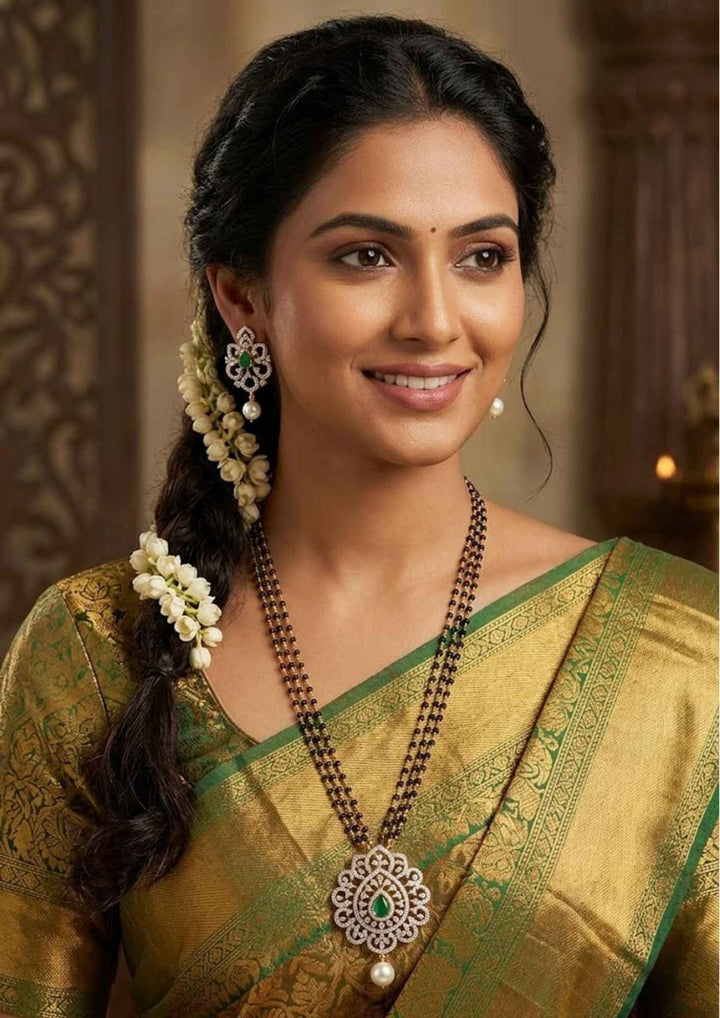 South Indian woman styling a gold plated diamond replica black beads mangalsutra chain with delicate zircon hanging drops and sleek lightweight  pendant finish. The elegant necklace combines traditional mangalsutra black bead detailing with a modern diamond look pendant, perfect for sarees, kurtis, casual ethnic wear and regular daily use.