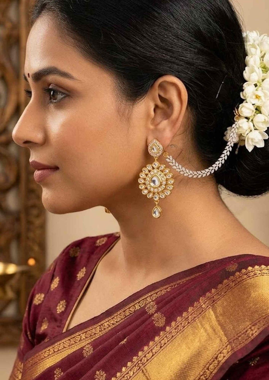 South indian women wearing gold plated laurel leaf mattilu ear chain set over a dark blue background displaying marquise stones that give a graceful traditional and modern look for grand functions with COD.