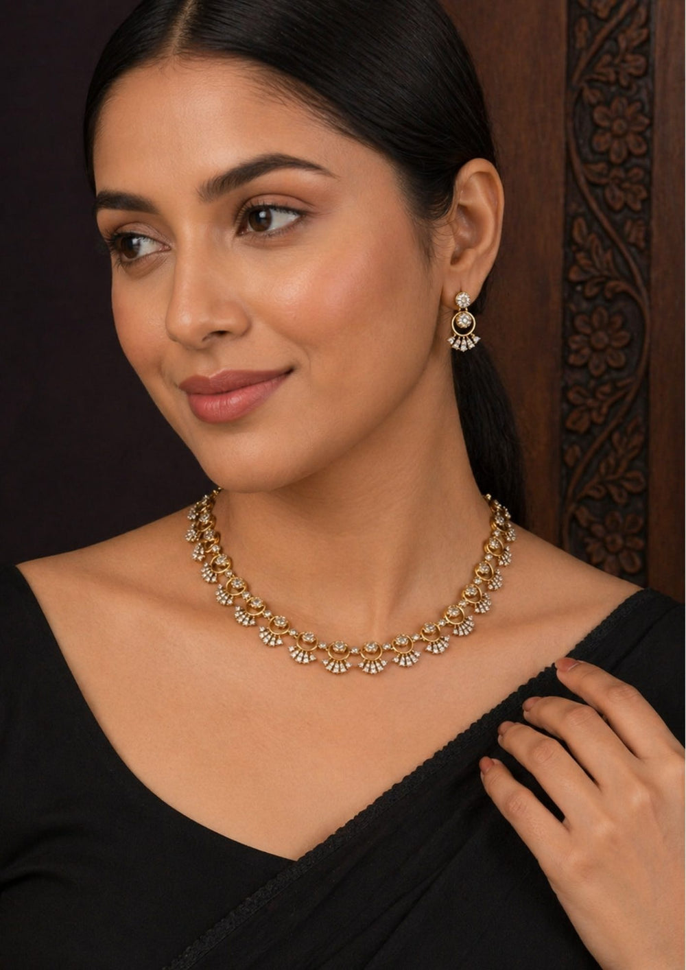 South indian women wearing Front angle presentation of a zircon diamond gold plated dainty choker necklace set against a dark background emphasizing the matching fan-fringe drop earrings.