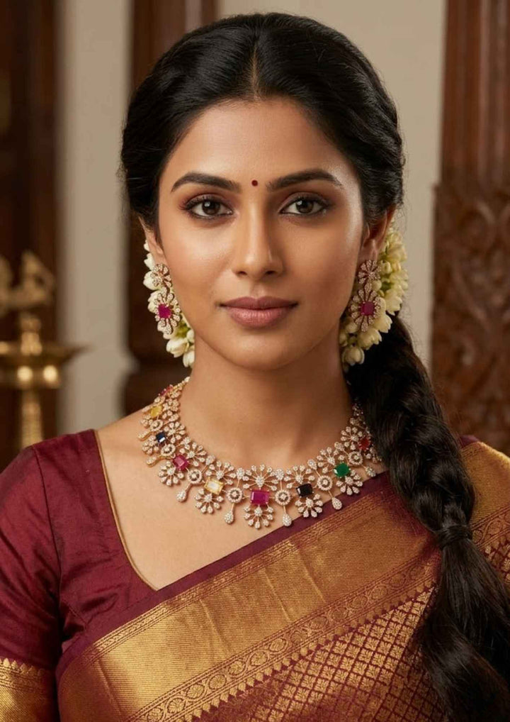 South Indian women wearing a premium zircon diamond gold plated necklace and matching earrings designed with shimmering clear stones and vibrant multi-color jewel accents that give a graceful modern royal look with lightweight comfortable use