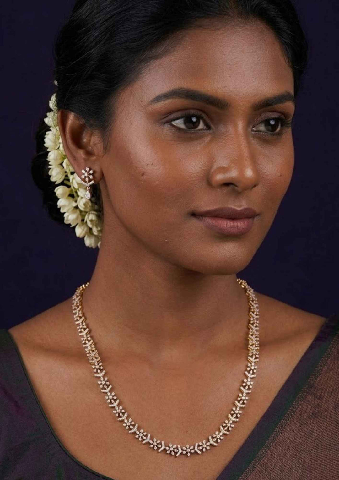 South Indian women waering a pure Zirconian diamond 18k gold plated long haram set showing a continuous shimmering white stone link pattern and matching dangles that give a graceful traditional and modern look for grand functions with COD.