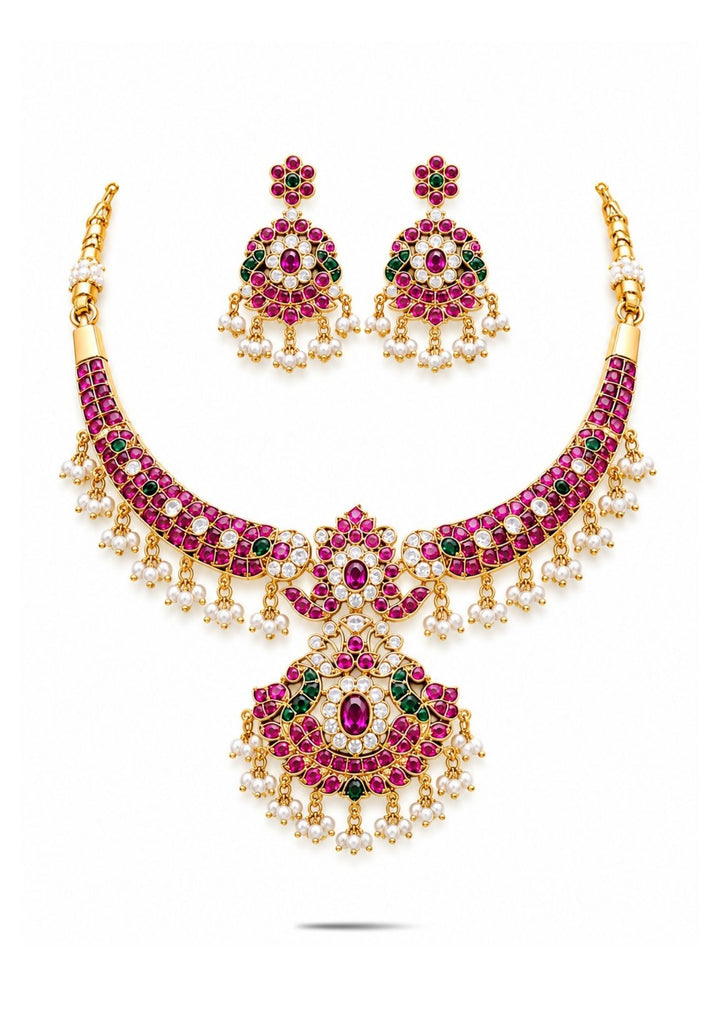 Jadau Kundan Gold Plated choker necklace and matching hanging earrings are designed with red ruby, emerald green, and clearly shown in white background and white Kundan stones, finished with delicate white pearl guttapusallu upto the bottom borders. perfect for a rich, bridal-style look perfect for weddings, festivals, functions and grand look