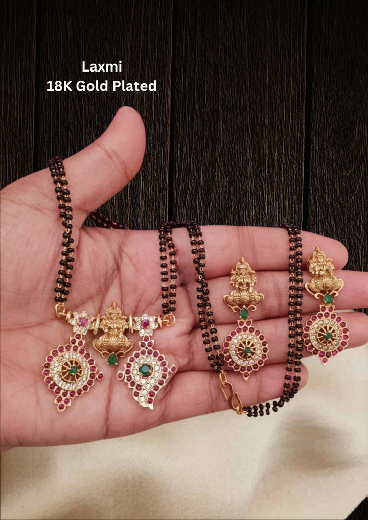 gold plated traditional mangalsutra which i temple jewelry penedent shows very clear shanku chakra   namallu with laxmi devi and earrings with laxmi devi and its very traditional  south idian women wear for festivals, functions