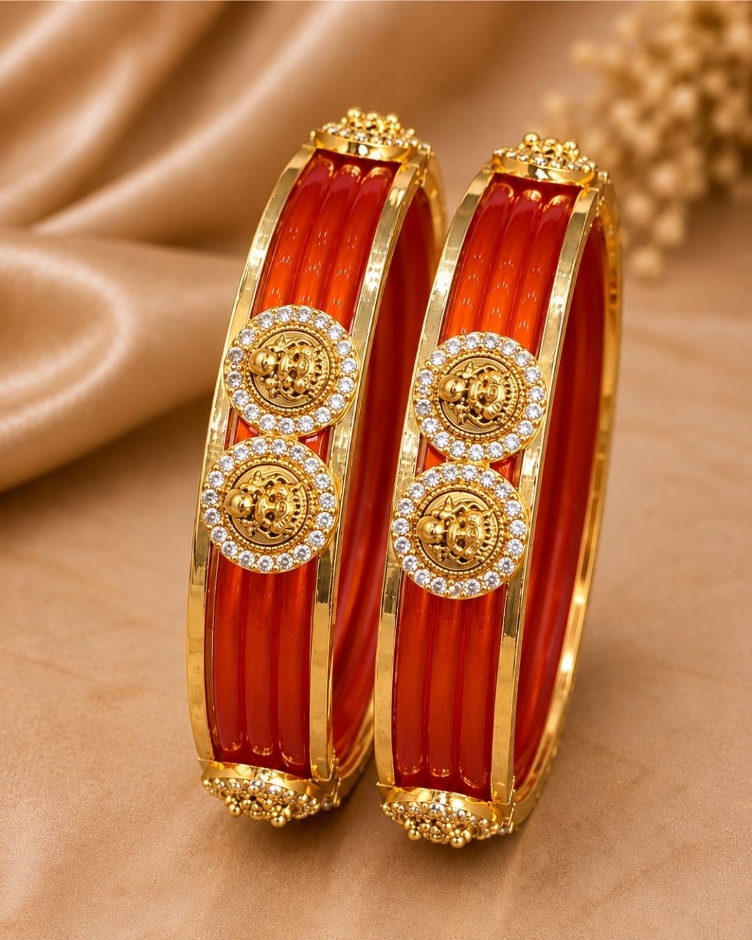 Traditional gold plated interchangeable bangles featuring rich red detailing, polished gold borders, circular motifs embellished with sparkling white stones, and decorative bead accents, perfect for festive, wedding, and traditional occasions.