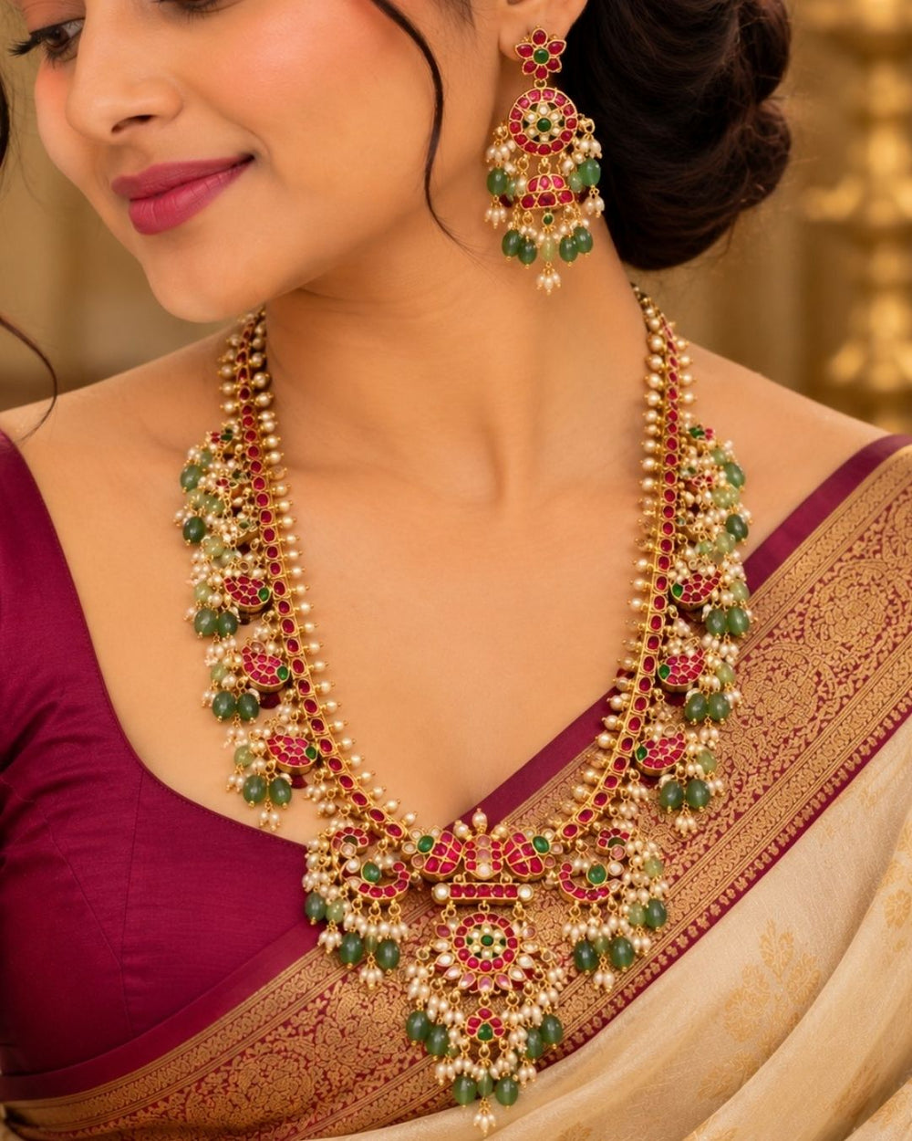 Gold necklace Set with a detailed pendant and earrings  on a white background with green and red stones come with jadau kundan in necklace set with beads and in pendent shows clear design and in detailed shown in picture it will not fade color and water proof can used for festivals, bridals, and weeding's  
