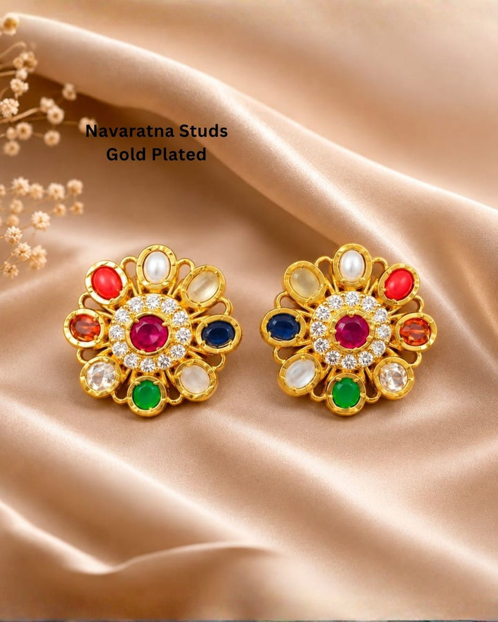 Beautiful gold plated floral earrings featuring a ruby-tone center, vibrant red, blue, green, and clear stones, pearl accents, and sparkling crystal detailing, perfect for festive occasions, weddings, parties, and traditional looks.