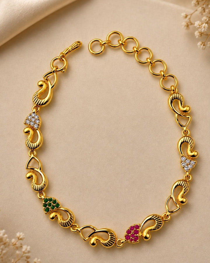 Stylish gold plated peacock design bracelet featuring intricate traditional motifs, vibrant green and ruby stone accents, sparkling white detailing, and an elegant linked pattern. Perfect for festive occasions, traditional outfits, weddings, parties, and special events.
