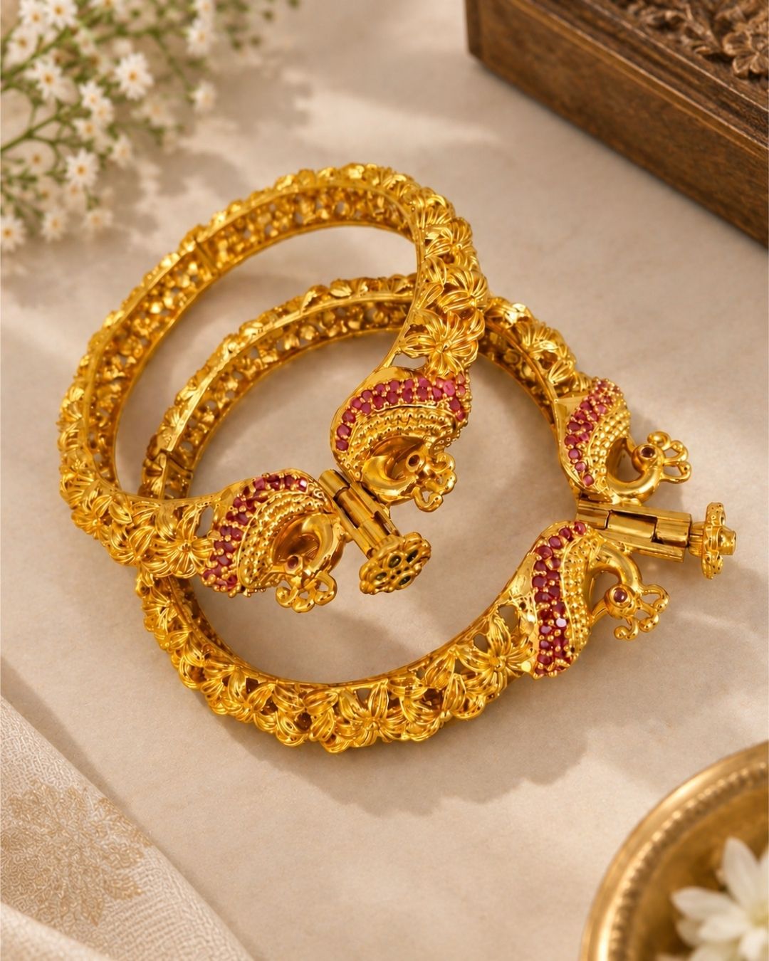 Designer Openable Peacock Gold Plated Kankanalu with floral engraved detailing, ruby-inspired embellishments, intricate craftsmanship, and an elegant hinged design.