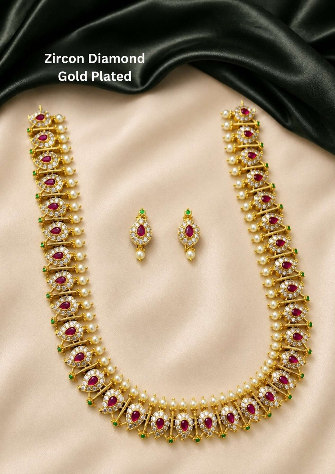 Elegant ruby zircon gold plated necklace set featuring pear-shaped ruby stones, sparkling zircon detailing, pearl drops, and matching earrings. Perfect for weddings and festive occasions.