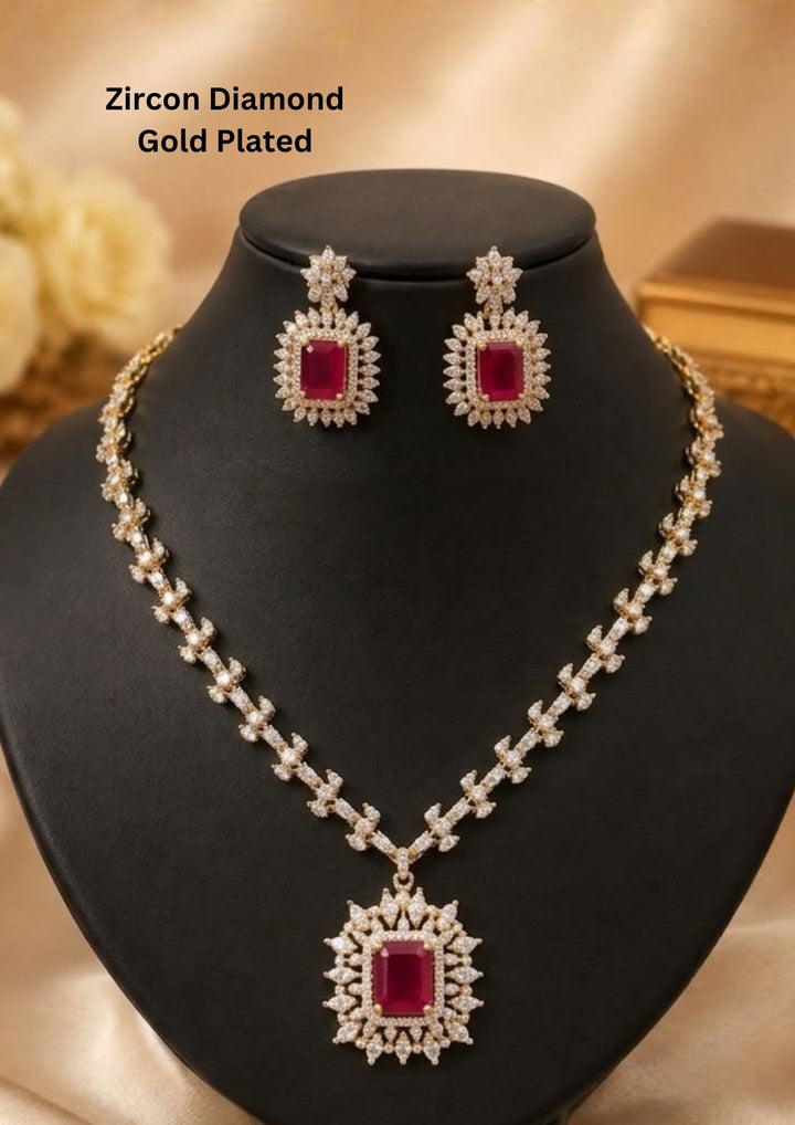 Gold-plated zircon diamond necklace and matching drop earrings. The necklace features a large rectangular red gemstone pendant surrounded by clear stones, with a matching pair of earrings above it. Perfect for weddings, receptions, festive occasions, and gifting.