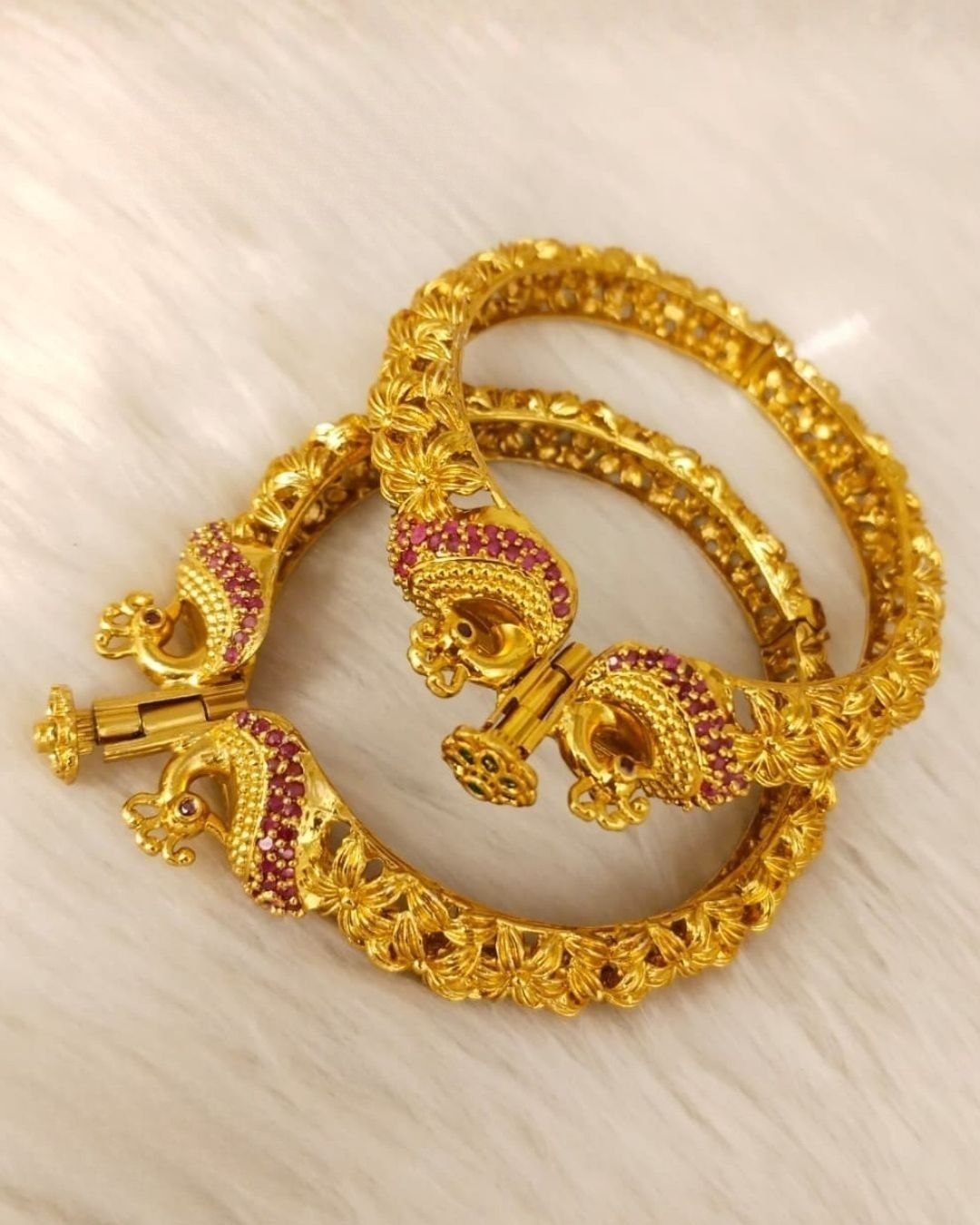 Designer Openable Peacock Gold Plated Kankanalu with floral engraved detailing, ruby-inspired embellishments, intricate craftsmanship, and an elegant hinged design.