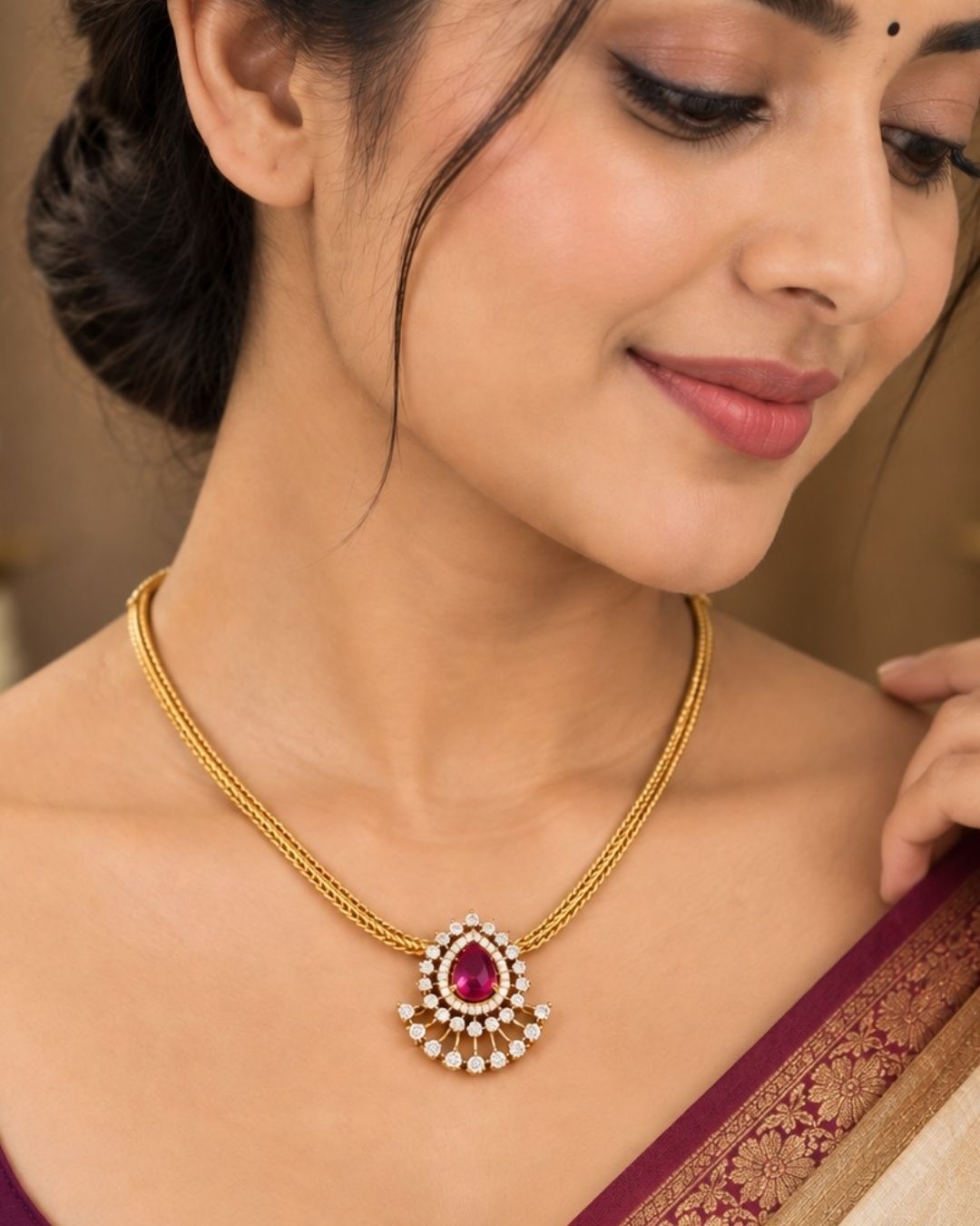South indian women wearing a pure Zircon diamond gold plated pink ruby teardrop pendant set showing a flat golden chain and matching studs that give a graceful traditional and modern look for daily wear and office gifting with COD.