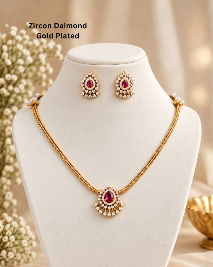 South indian women wearing a pure Zircon diamond gold plated pink ruby teardrop pendant set showing a flat golden chain and matching studs that give a graceful traditional and modern look for daily wear and office gifting with COD.