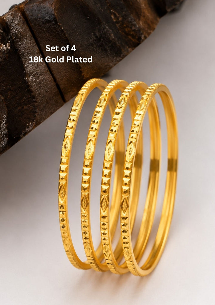 Elegant set of four 18K gold plated bangles featuring a smooth polished finish with brilliant diamond-cut shine.
Lightweight, stylish, and comfortable for all-day wear.
Perfect for office wear, weddings, festive occasions, and daily styling.