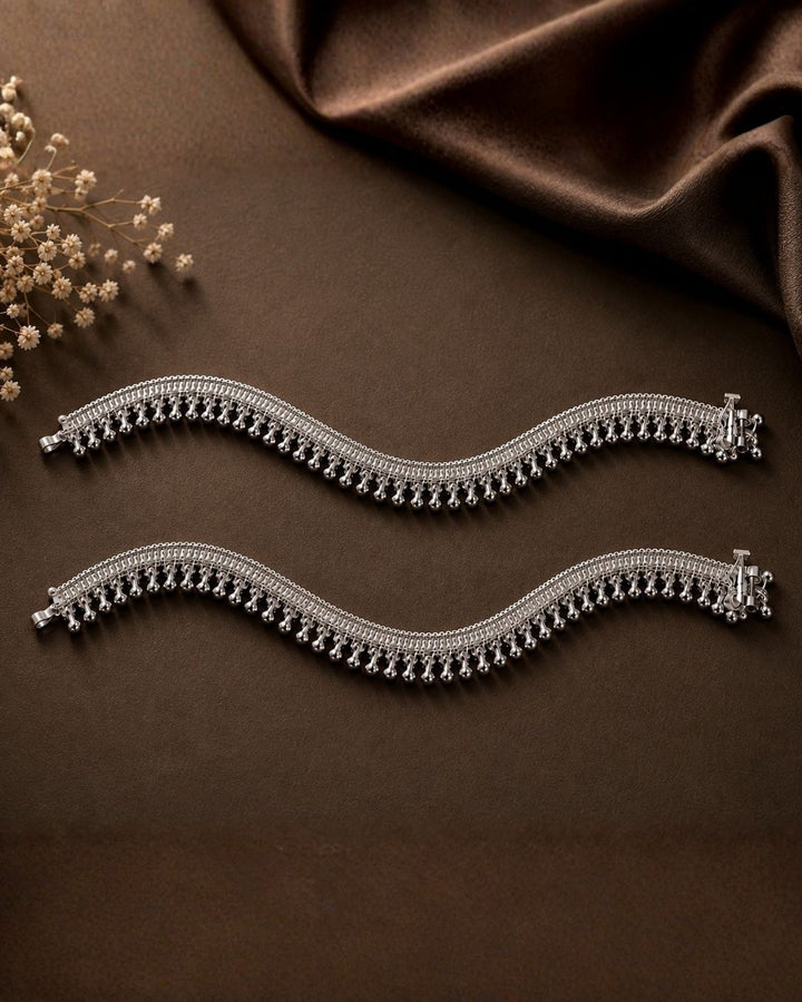 Beautiful silver plated designer payal set featuring intricate layered chain detailing and numerous delicate hanging silver beads. Perfect for traditional occasions, festive wear, daily wear, and gifting.