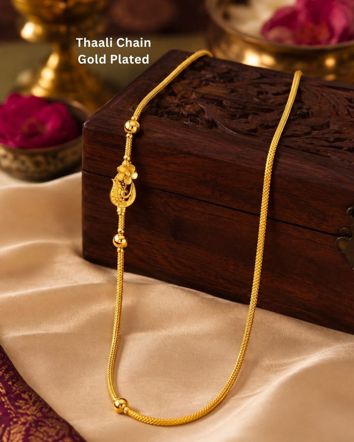 Elegant gold plated Thaali chain featuring a beautifully detailed traditional floral pendant, gold bead accents, and a refined chain design, perfect for daily wear, festive occasions, and traditional looks.