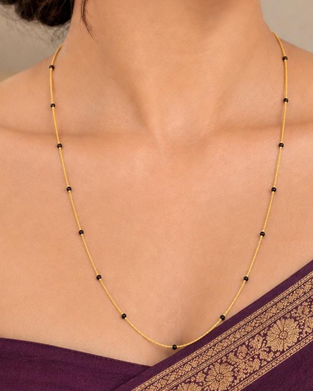 Beautiful Mangalsutra featuring a delicate gold plated chain with traditional black beads arranged along the chain. Perfect for daily wear, office wear, traditional outfits, festive occasions, and gifting.