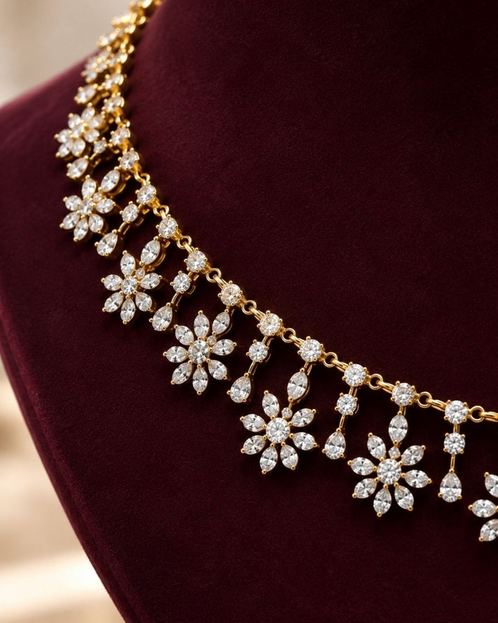 South Indian Woman wearing a Gold-plated zircon diamond necklace and earrings designed with floral pattern and tear drop in between the florals perfect for weddings, parties, functions.