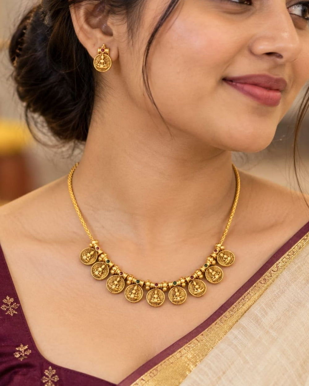 Antique gold plated South Indian coin necklace set with Goddess Lakshmi motifs and matching earrings for festive and traditional wear.