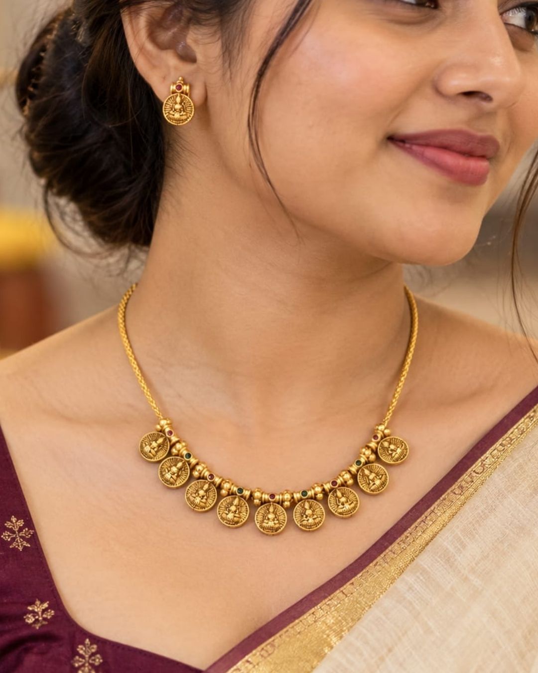 Antique gold plated South Indian coin necklace set with Goddess Lakshmi motifs and matching earrings for festive and traditional wear.