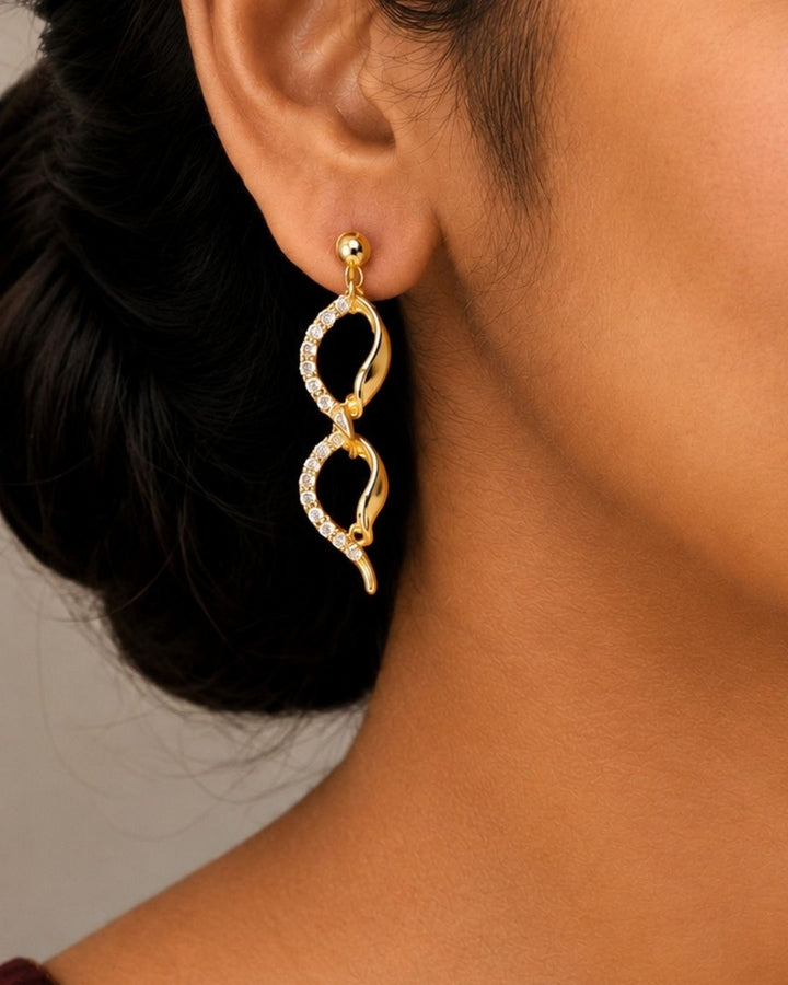 South Indian women Beautiful gold plated loop necklace set featuring interlinked curved motifs accented with sparkling clear stones and matching elegant drop earrings. Perfect for daily wear, festive occasions, parties, traditional outfits, and premium gifting.