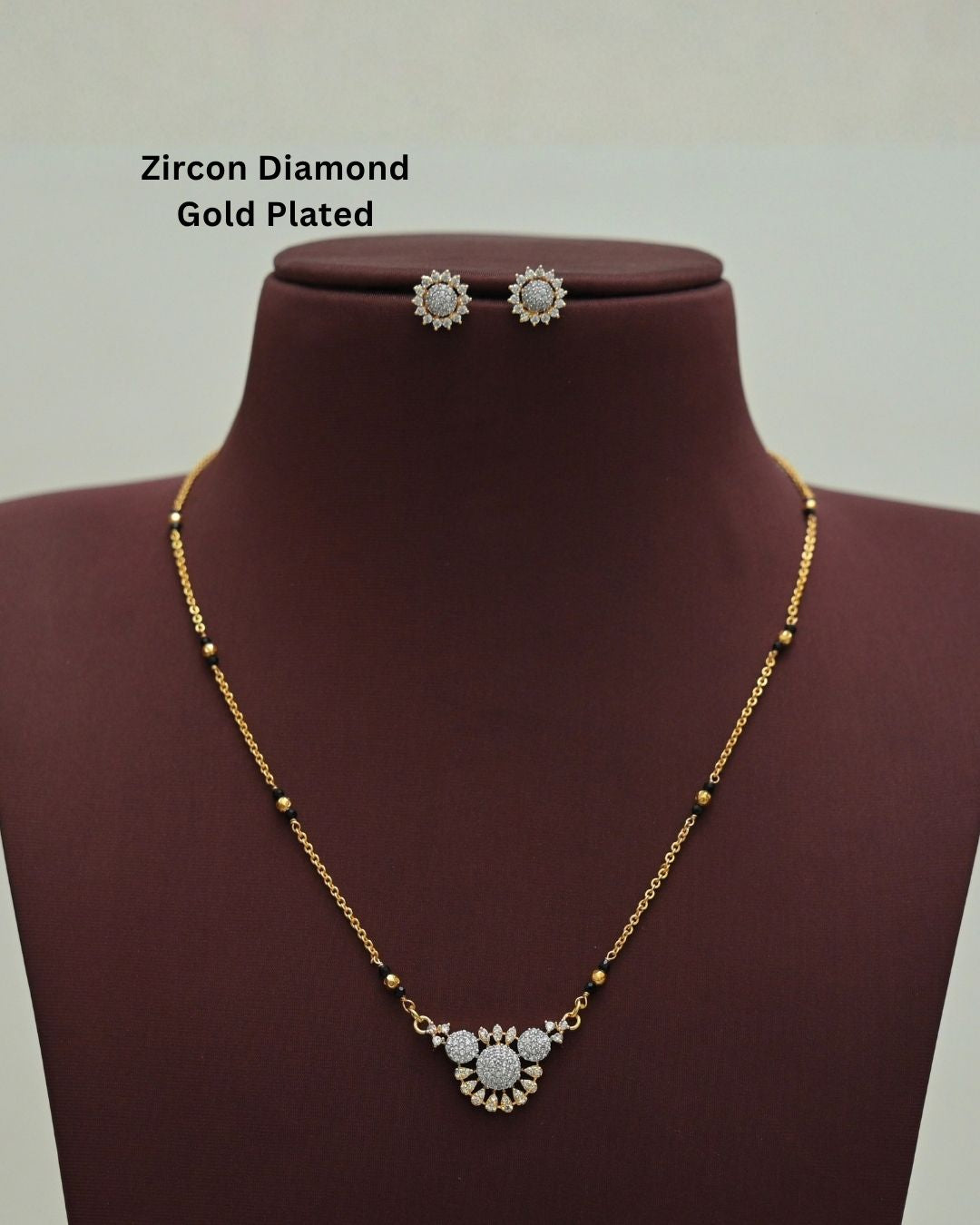 Stylish gold plated necklace set featuring a delicate black beaded chain, sparkling zircon diamond floral pendant, and matching sun-inspired stud earrings, perfect for everyday and festive wear.