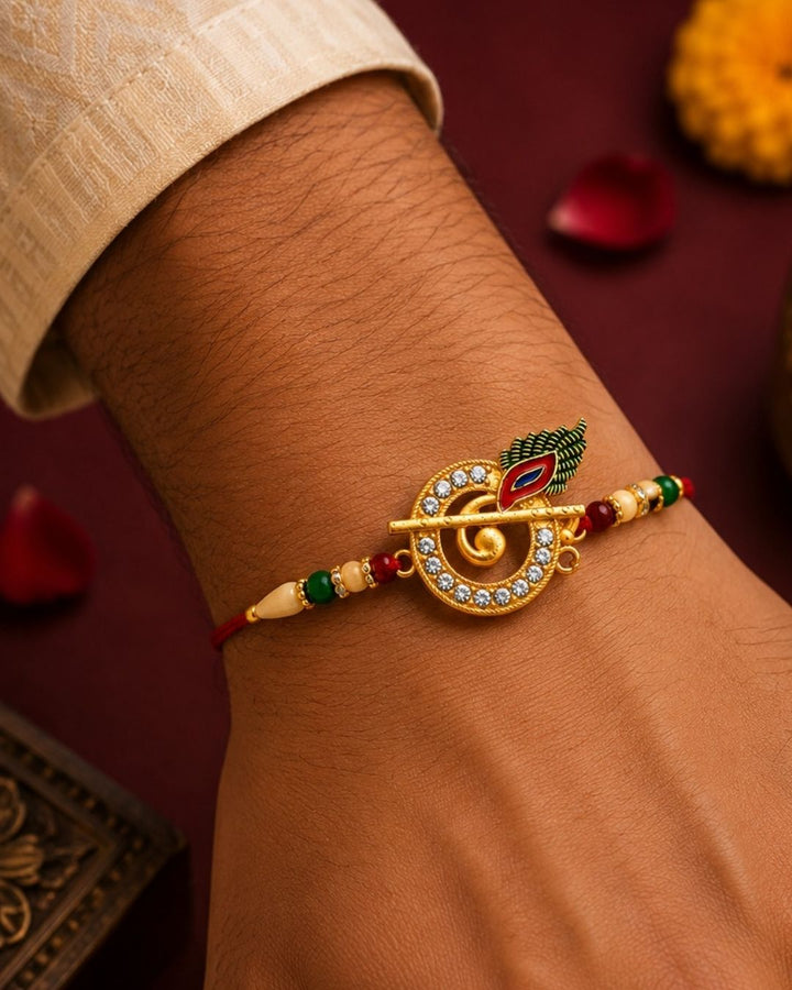 Beautiful Krishna Flute Rakhi designed with a golden bansuri, peacock feather charm, shimmering stones, and vibrant beads. Perfect for Raksha Bandhan celebrations, traditional gifting, festive wear, and expressing love and blessings for your brother.