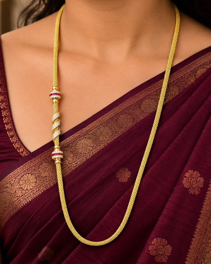 Beautiful gold plated thaali chain featuring an elegant woven pattern with ruby and CZ stone embellished decorative elements. Perfect for traditional wear, weddings, festive occasions, and gifting.