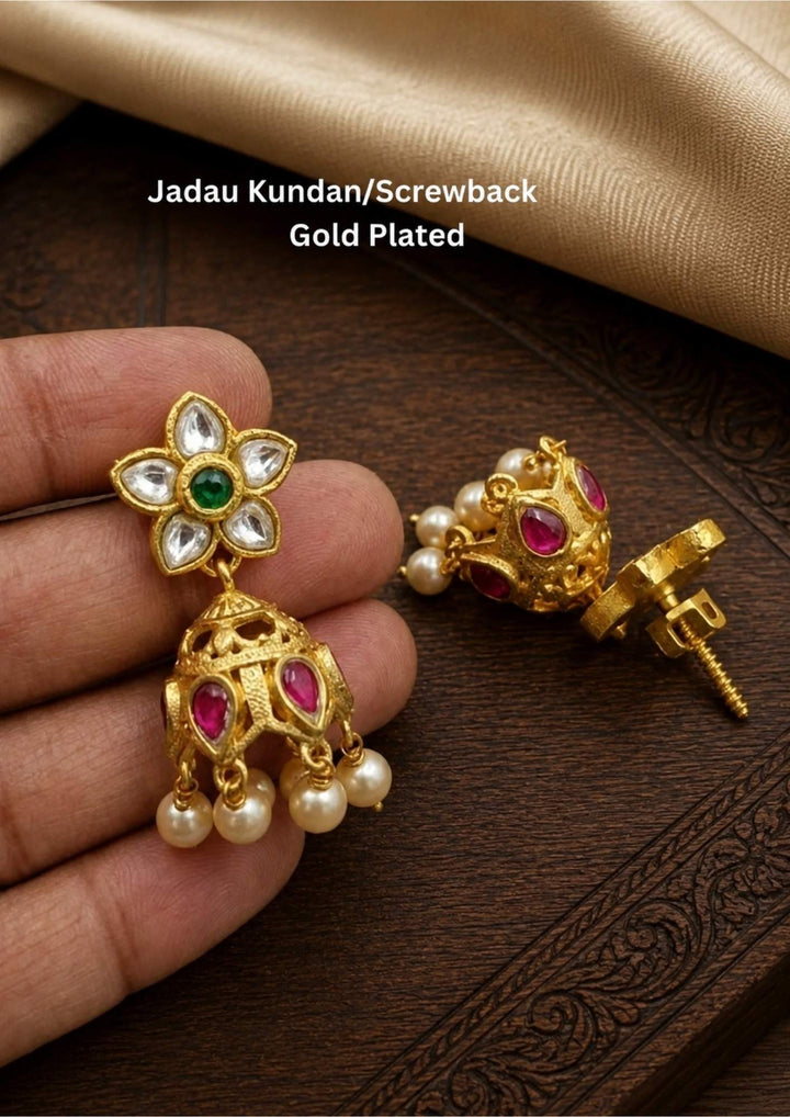 Gold plated earrings with gemstones and pearls jhumaks with waterproof, anti fade used for dailyware ,festivals weddings, and ideal for gifting.