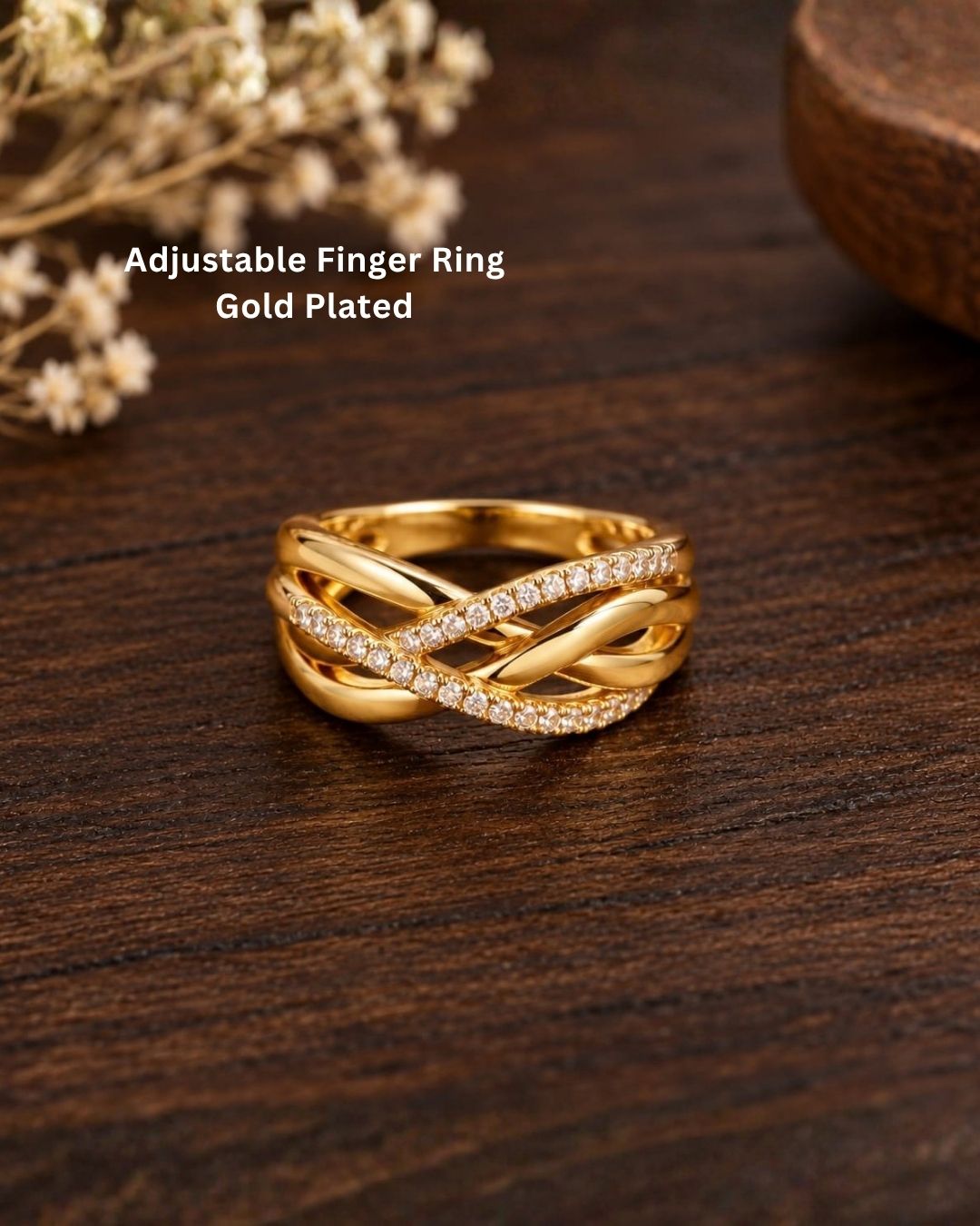 Stylish gold plated adjustable ring with a layered crossed-band design and sparkling crystals, perfect for everyday and occasion wear.