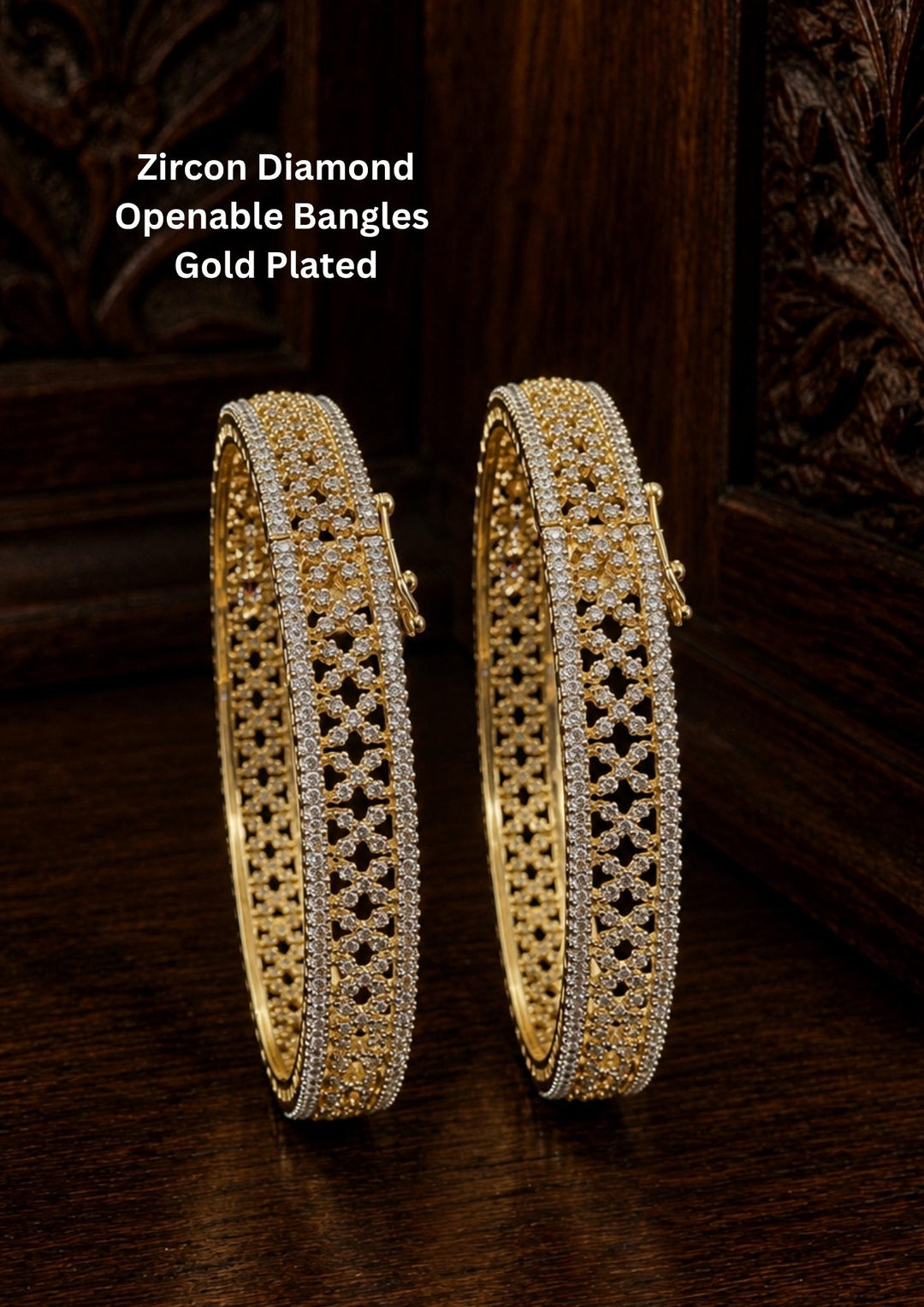 A stunning pair of 18k gold plated bangles featuring intricate open lattice craftsmanship with rows of shimmering white zircon stones along the borders. The broad kada-style bangles showcase a luxurious diamond-like finish with secure clasp closures, making them ideal for weddings, festive occasions, and traditional outfits.