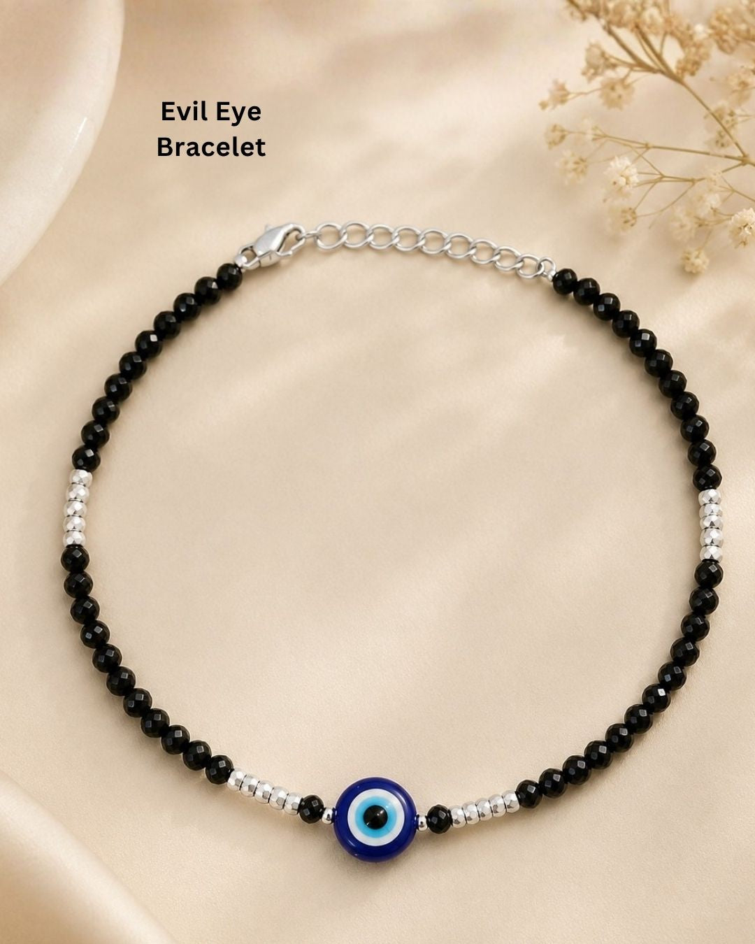 Beautiful black beaded evil eye bracelet featuring faceted black beads, silver bead accents, and a striking blue evil eye centerpiece. Perfect for daily wear, casual outfits, gifting, and stylish occasions.
