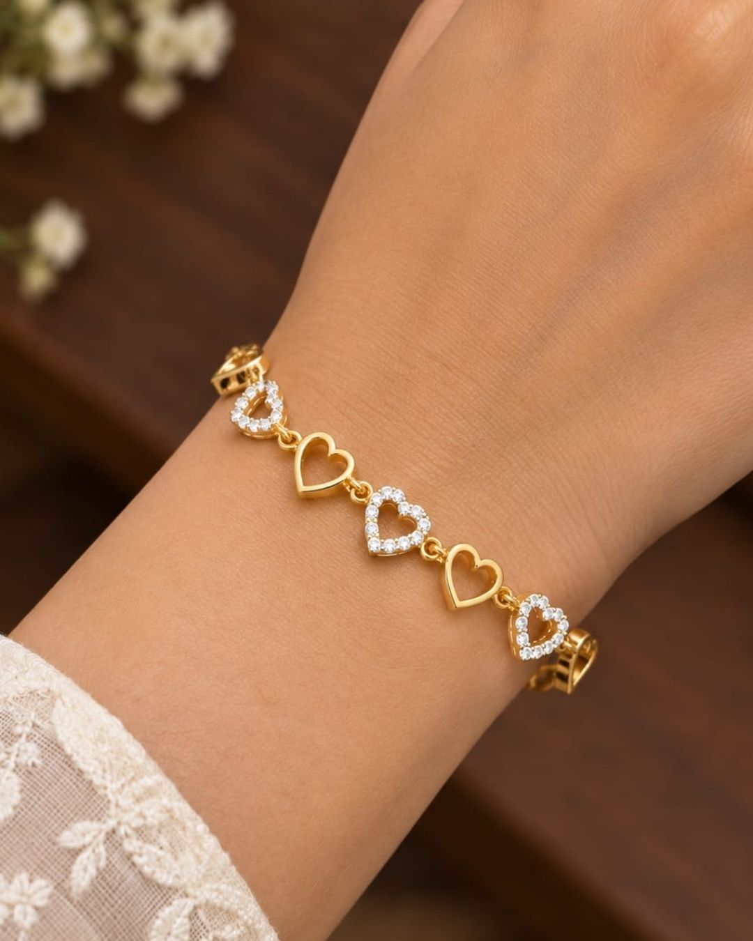 Elegant gold plated women’s bracelet featuring multiple heart-shaped charms, sparkling zircon detailing, and a classic link-chain design, perfect for everyday and special occasions.