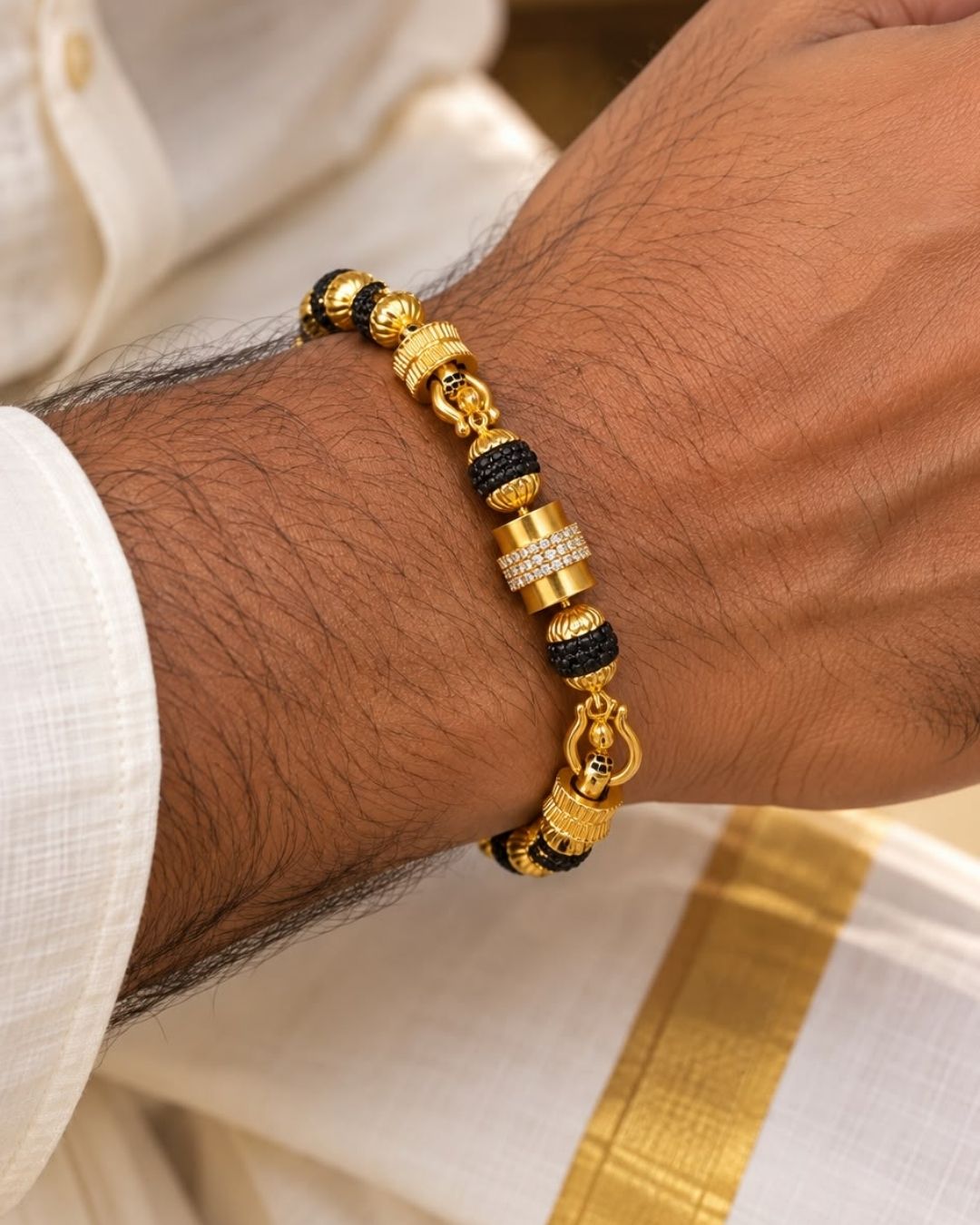 Elegant gold plated men’s bracelet featuring black textured beads, ornate gold accents, and a detailed clasp design, perfect for daily wear, festive occasions, and traditional looks.