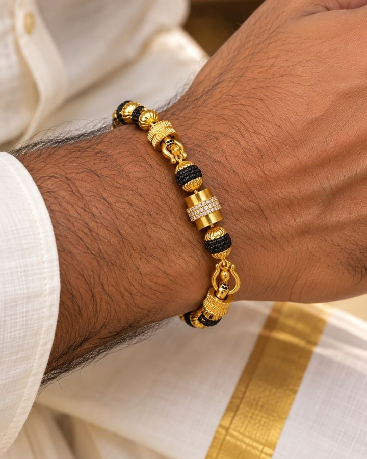 Elegant gold plated men’s bracelet featuring black textured beads, ornate gold accents, and a detailed clasp design, perfect for daily wear, festive occasions, and traditional looks.