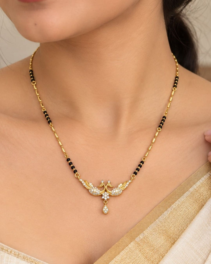 Traditional gold plated mangalsutra featuring black beads, detailed gold accents, a sparkling CZ pendant, and a delicate teardrop embellishment, perfect for everyday and festive wear.