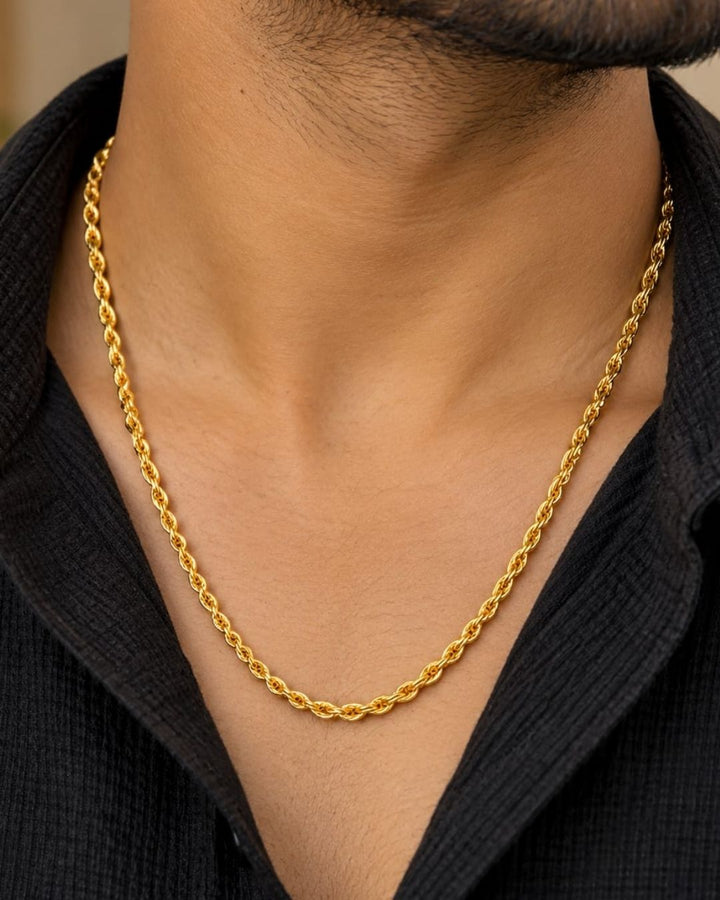 Gold plated men’s chain displayed in hand, highlighting its twisted links and shiny finish.