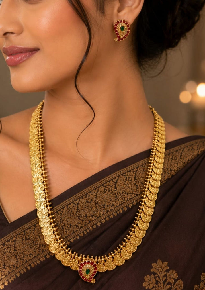 Traditional South Indian antique gold plated Laxmi Kasulaperu haram necklace set designed with structured gold coin arrays, ruby accents, and an elegant matte gold finish that gives a graceful traditional look for festive celebrations, poojas, family functions, and bridal outfits with lightweight comfortable use
