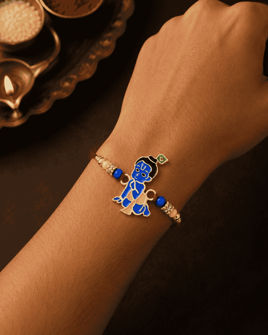 Beautiful Bal Krishna gold plated Rakhi featuring a colorful Lord Krishna design with decorative beads and premium craftsmanship. Perfect for Raksha Bandhan celebrations and thoughtful gifting.