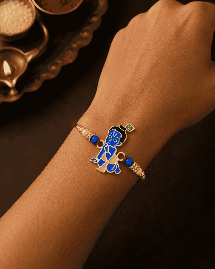 Beautiful Bal Krishna gold plated Rakhi featuring a colorful Lord Krishna design with decorative beads and premium craftsmanship. Perfect for Raksha Bandhan celebrations and thoughtful gifting.