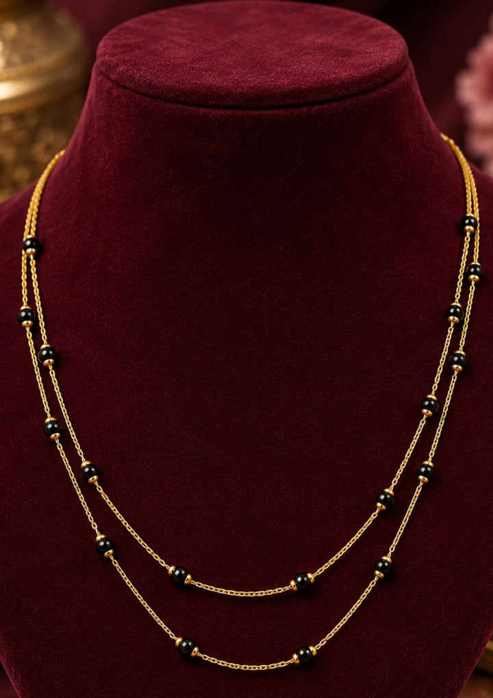 Beautiful 18K gold plated double layer black beads mangalsutra chain featuring a sleek minimalist design and elegant craftsmanship. Perfect for daily wear, office wear, festive occasions, traditional outfits, and premium gifting.