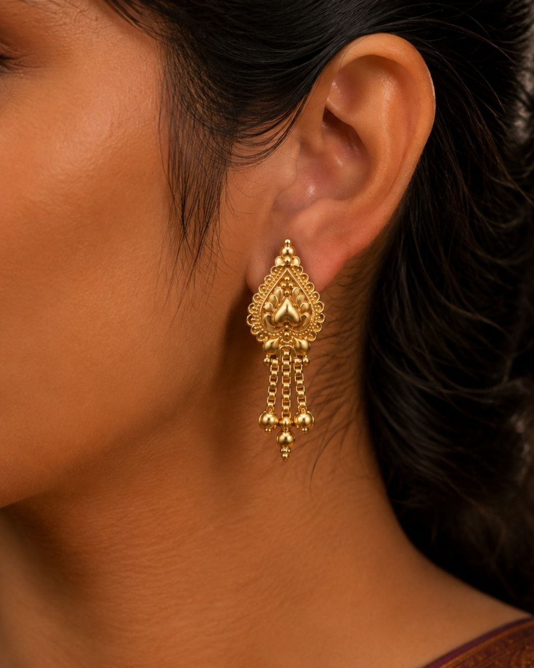 Premium gold plated traditional earrings featuring an ornate teardrop design with intricate craftsmanship, cascading chains, and delicate gold bead accents. Perfect for sarees, festive occasions, weddings, classical dance performances, and traditional events.