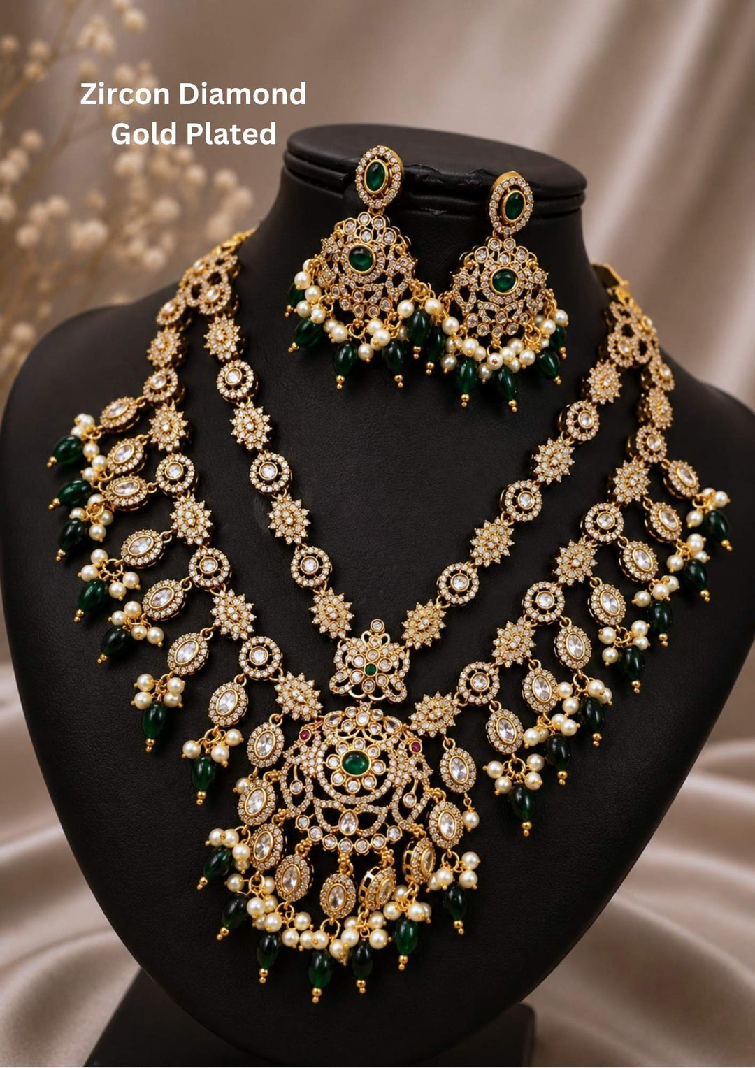 gold plated heavy bridal jewelry set featuring a double-layered design with an inner floral diamond chain and an outer structured haram layer connected to a grand circular medallion pendant. The piece is richly adorned with pure zirconian diamonds, green emerald center stones, and hanging clusters of white pearls and emerald green beads. The matching heavy jhumka earrings with royal design. Perfect for weddings, grand receptions, festivals, and traditional family functions with skin-friendly quality.