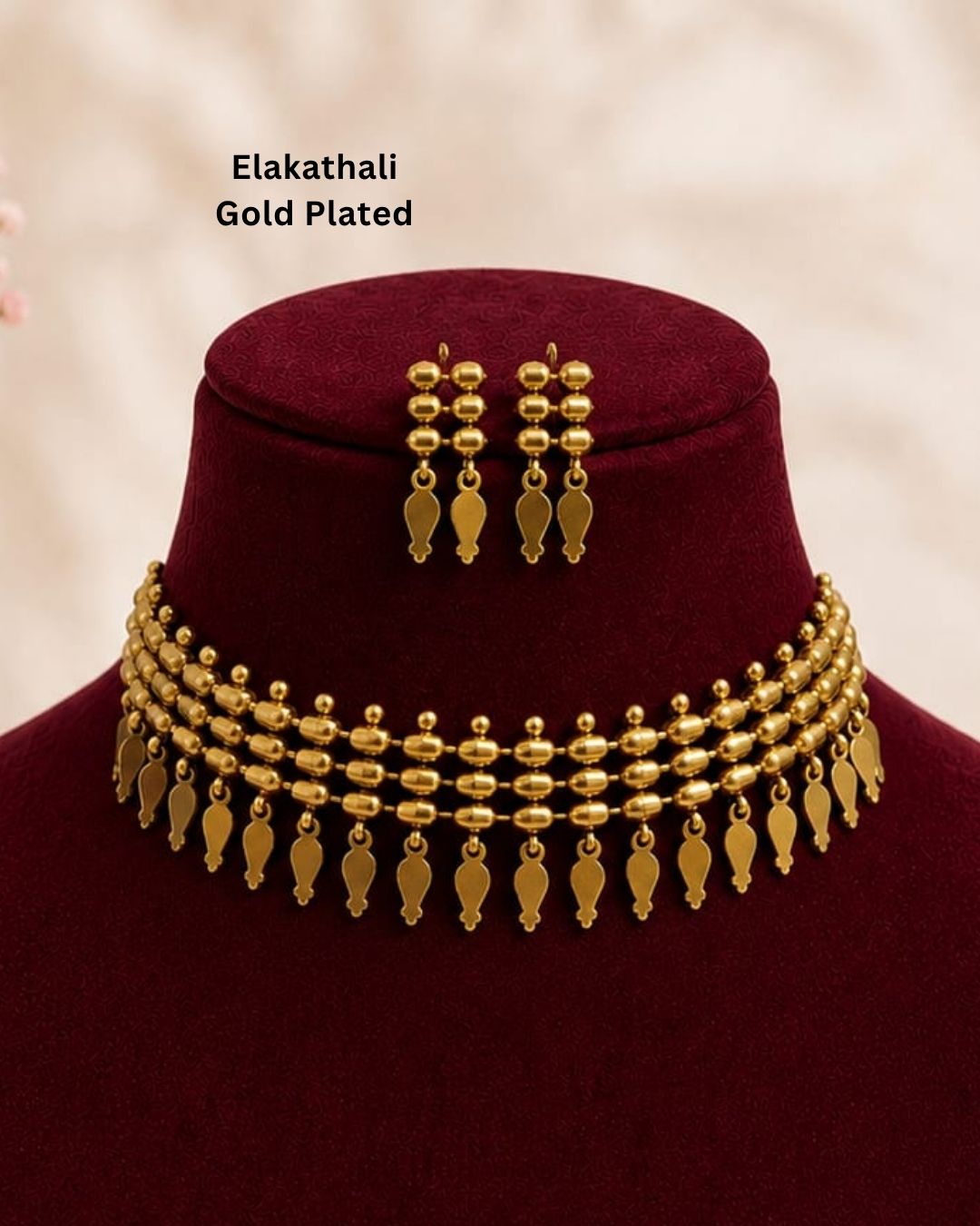 Beautiful gold plated choker necklace and matching earrings featuring multiple rows of textured beads and traditional leaf-shaped dangling elements. Perfect for festive occasions, traditional wear, daily wear, and gifting.