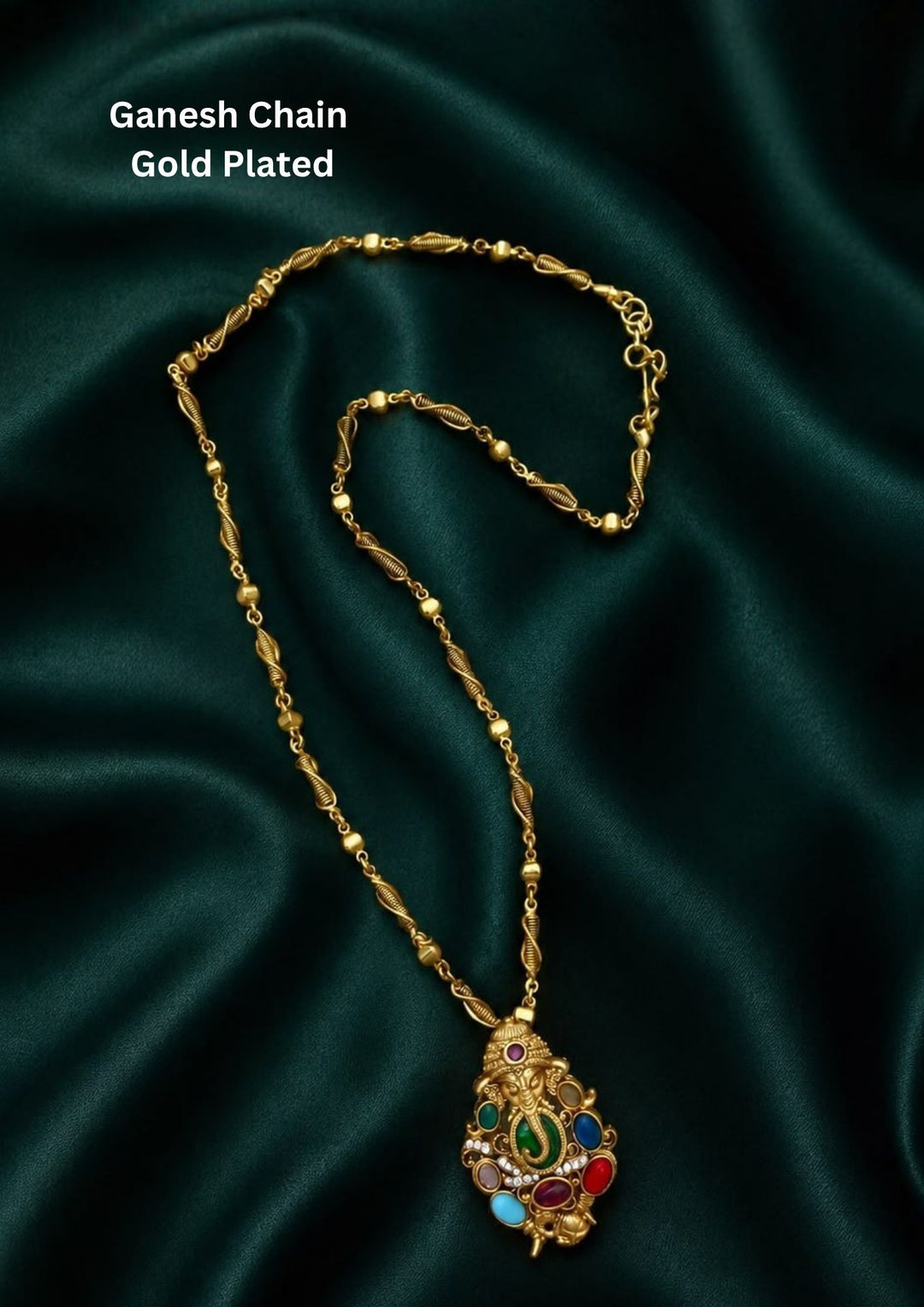 A beautiful gold-plated religious pendant chain featuring a detailed Lord Ganesh motif. The oval pendant is intricately crafted with an embossed Ganesha figurine at the center, surrounded by an array of vibrant, multi-colored smooth stones in shades of green, blue, red, pink, and turquoise, suspended from a textured twisted-link chain. Perfect for for bridal and festive wear. It is anti tarnish and skin friendly
