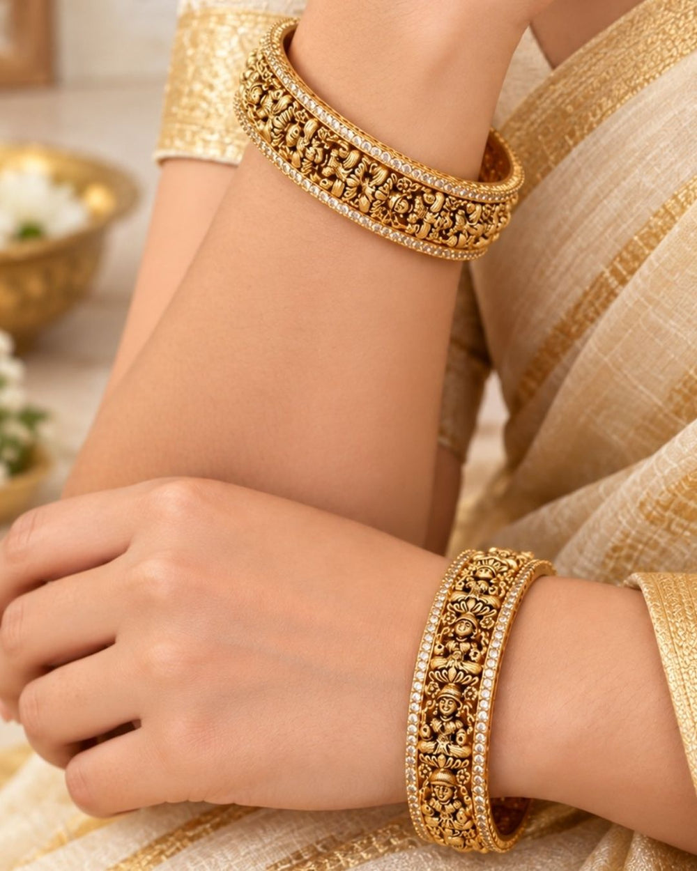 Elegant 18K gold plated designer bangles featuring repeated Goddess Lakshmi motifs, detailed craftsmanship, and zircon stone borders, perfect for festive and traditional wear.