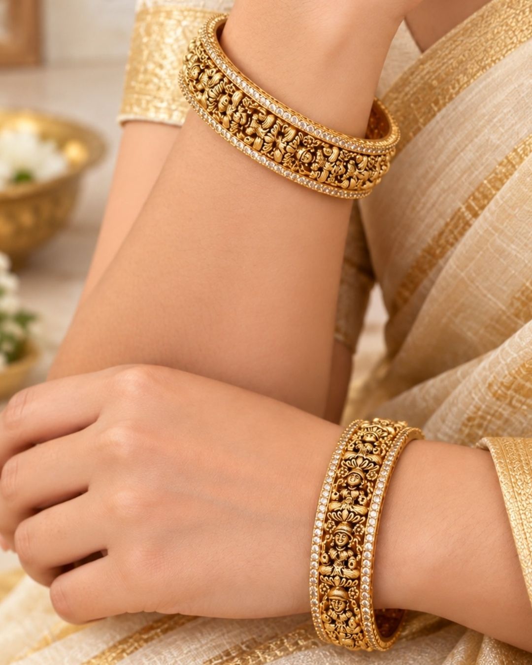 Elegant 18K gold plated designer bangles featuring repeated Goddess Lakshmi motifs, detailed craftsmanship, and zircon stone borders, perfect for festive and traditional wear.