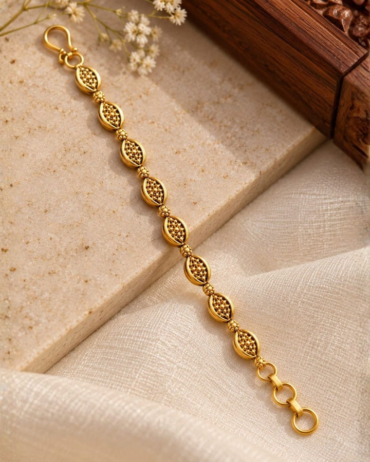 Gold plated traditional ear chains featuring intricate oval motifs, antique-style detailing, and decorative gold bead links.